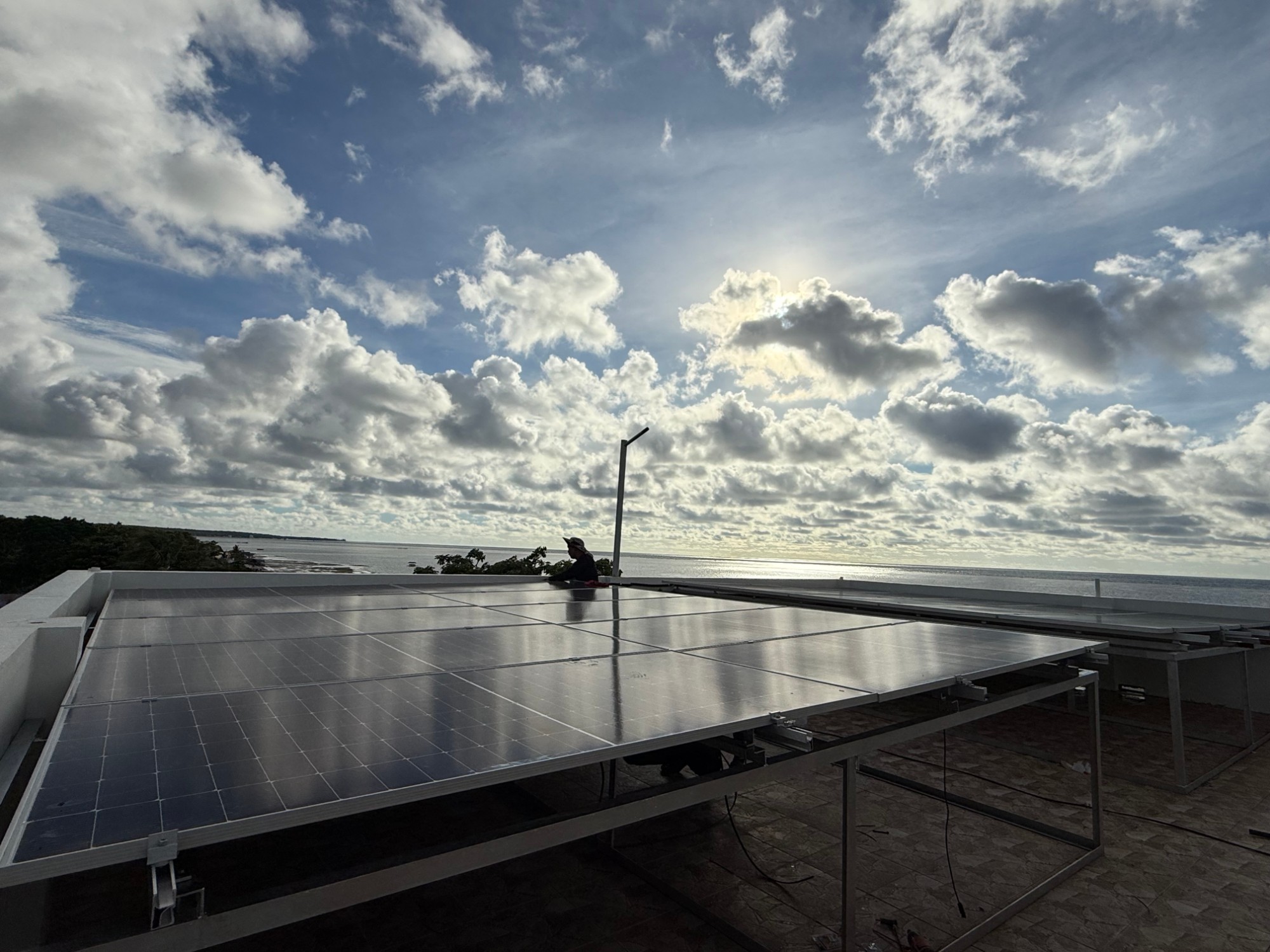 Bolinao Solar installer fitting rooftop solar panels on a home